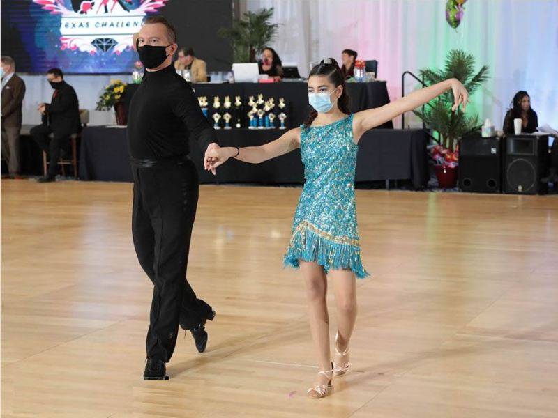 Denis dancing with student at dance competition